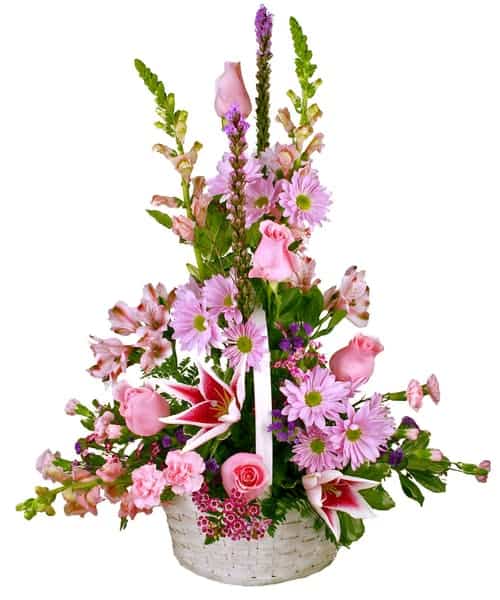 Send a promise of brighter days ahead with this perfect blend of pink and purple flowers. A white wicker basket is delicately filled with lilies, roses, carnations, daisies, snapdragons and more.