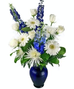 beautiful blue and white arrangement in a cobalt blue vase