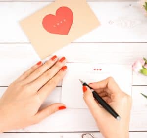 woman's hands writing a letter