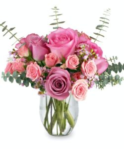 Charming lavender and pink flowers fill a vase. Roses, spray roses, and eucalyptus makes this a pretty, yet interesting, arrangement